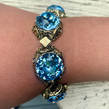 Load image into Gallery viewer, Vintage Brass Tone Filigree Faux London Blue Topaz Sparkling Large Cabochons Bracelet
