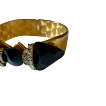 Load image into Gallery viewer, Vintage 1980’s Black Faux Onyx Gold Tone Rhinestone Bow Wide Hinged Bracelet
